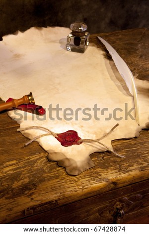 Empty parchment scroll with wax seal and feather quill
