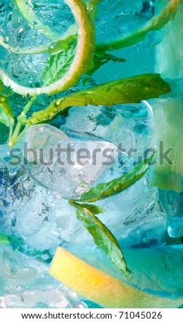 Extreme macro closeup of a blue cocktail drink with lemon slices