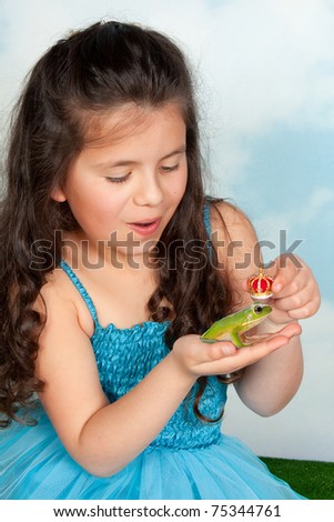 Fairy tale girl putting a golden crown on a frog prince