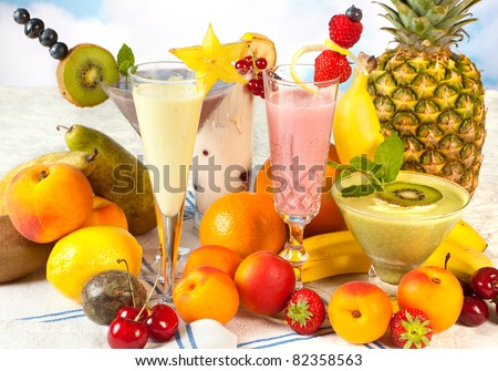 Diet table filled with summer fruits and colorful smoothies