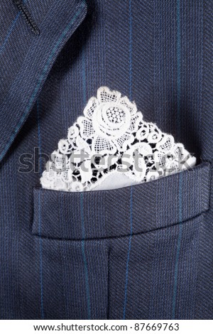 Formal suit breast pocket with a lace white handkerchief