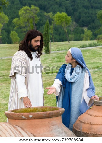 Biblical scene play of the miracle of transformation of water into wine - Mary saying to Jesus there is no wine left