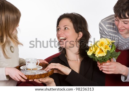 Happy mother receiving coffee and flowers on mother's day