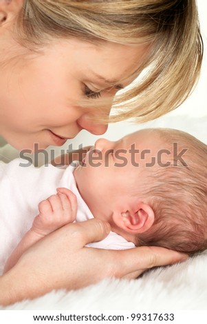 Loving moment of tenderness between a mother and her 18 days old baby