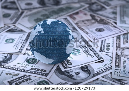Digital earth globe on heap of dollars