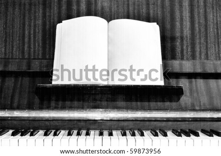 Old grunge piano keys with effect of old retro movie and note sheet