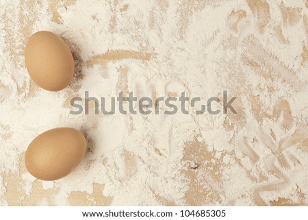 An Organic Brown Chicken Egg on a floured board