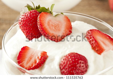 Fresh Organic Greek Yogurt with strawberries on a background