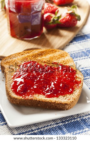 Homemade Organic Red Strawberry Jelly on a piece of toast