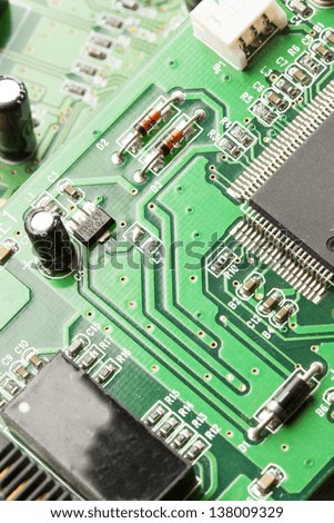 Green Electrical Circuit Board with microchips, conductors, and transistors