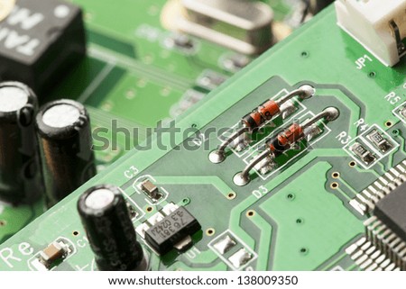 Green Electrical Circuit Board with microchips, conductors, and transistors