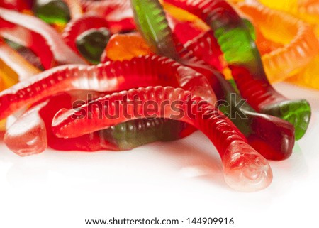 Colorful Fruity Gummy Worm Candy on a background