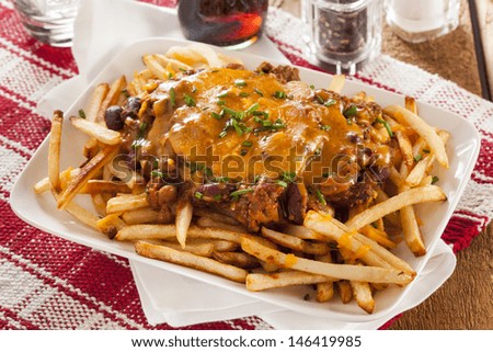 Unhealthy Messy Chili Cheese Fries on a Background