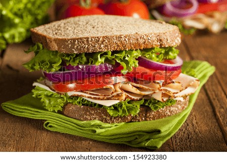 Homemade Turkey Sandwich with Lettuce, Tomato, and Onion