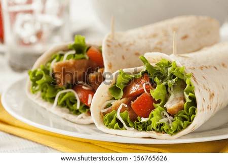 Breaded Chicken In A Tortilla Wrap With Lettuce And Tomato