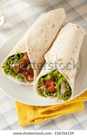Breaded Chicken in a Tortilla Wrap with Lettuce and Tomato