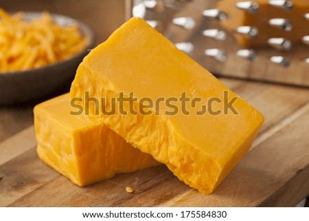 Organic Sharp Cheddar Cheese on a Cutting Board