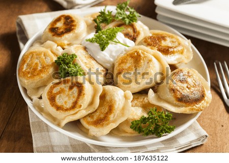 Homemade Polish Pierogis with Sour Cream and Parsley