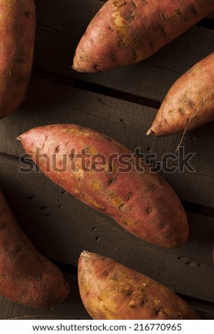 Organic Raw Sweet Potatoes on a Background