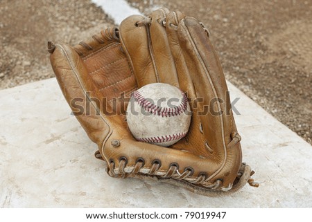 A baseball glove  in a baseball field