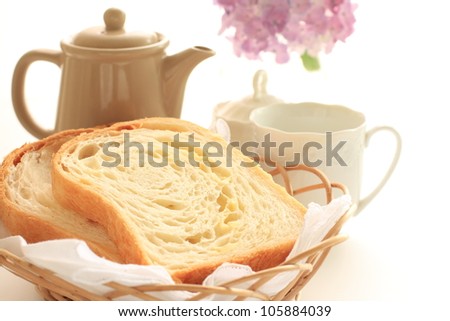 Homemade cheese Danish bread in bamboo basket with tea and hydrangea