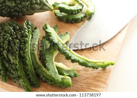 bitter melon on wooden chopping board for chinese cooking image