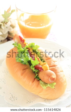 Tasty hot dog and orange juice for fast food image