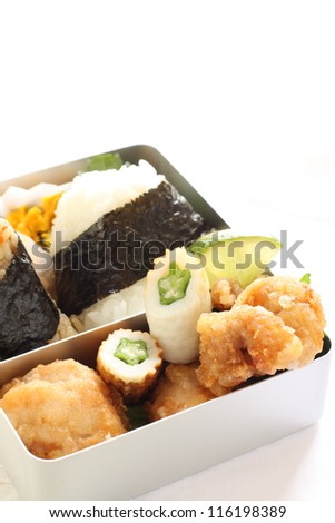 Japanese food, rice ball and fried chicken packed lunch in stainless box