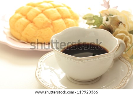 black coffee and Japanese melon bread with flower for elegant breakfast image