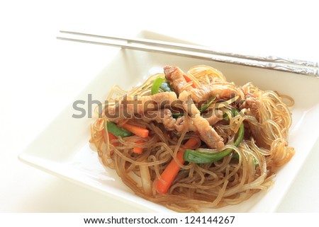 korean cuisine, pork and vegetable japchae on white square dish