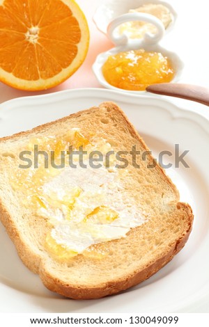 Butter and marmalade on toast for breakfast image
