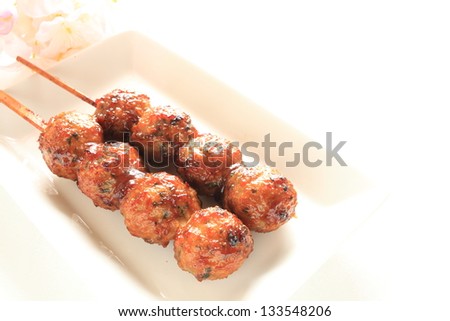 japanese cuisine, chicken meat ball Yakitori Tsukune with flower on background