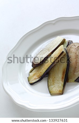 pan fried eggplant slice on white dish with copy space for nutrition food image