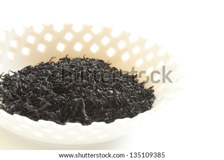 japanese food, dried edible brown algae on white bowl with copy space