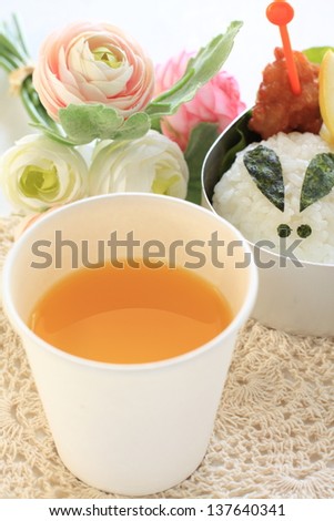 orange juice in paper cup with cutie Japanese obento for picnic food image