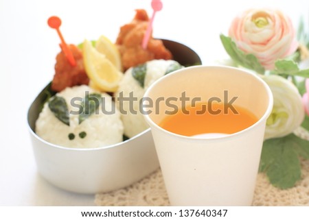 orange juice in paper cup with cutie Japanese obento for picnic food image