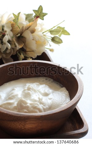 tropical food ingredient, coconut milk in wooden bow with copy space