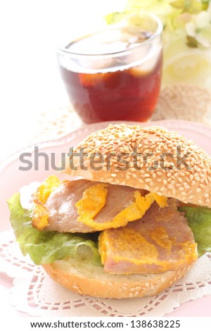 Hawaiian food, egg fried luncheon meat sandwiches and iced tea on white background