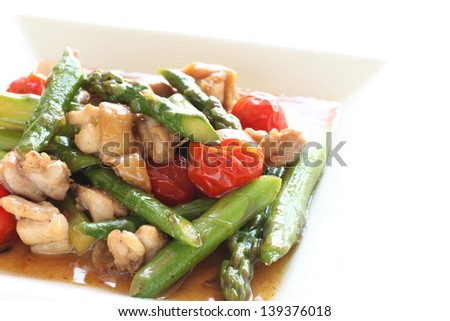 chinese cuisine, asparagus and chicken stir fried with cherry tomato