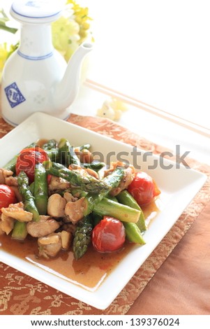 chinese cuisine, asparagus and chicken stir fried with cherry tomato