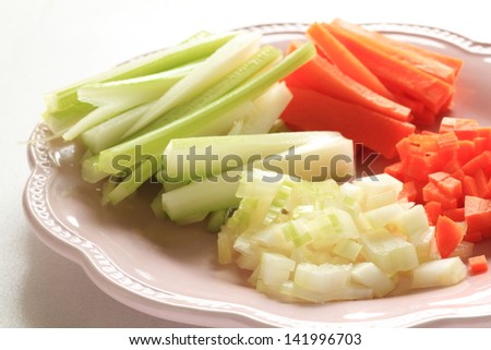 sliced celery and carrot on pink dish for food ingredient image
