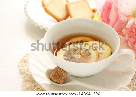 lemon tea and cookie with brown sugar on side for afternoon tea image