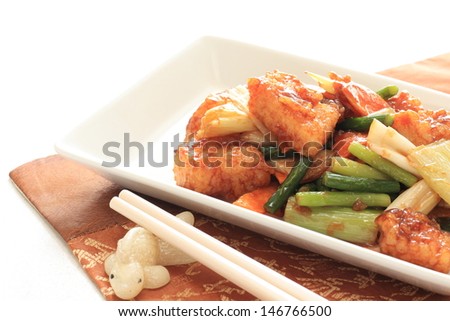 chinese cuisine, squid and vegetable stir fried on white square dish