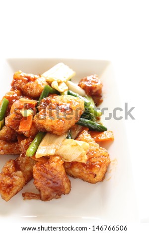 chinese cuisine, squid and vegetable stir fried on white square dish