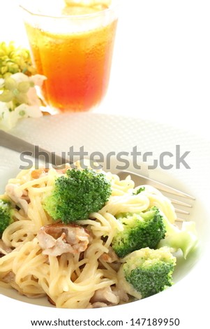 italian food, broccoli and pork spaghetti with lemon tea on white background