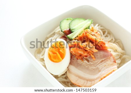 Gourmet Korean cuisine,  cold noodles with egg and Kimichi on top for gourmet lunch menu