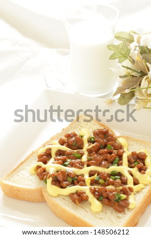 Japanese fusion food, Natto and mayonnaise on toast with milk and flower on background
