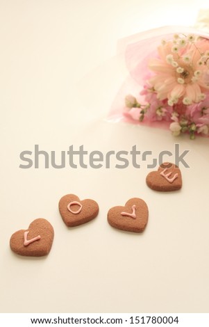 elegant flower bouquet and heart shaped cookie