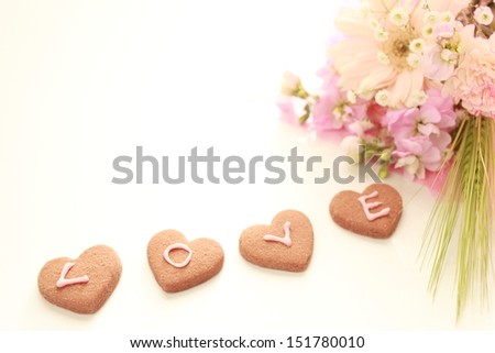 elegant flower bouquet and heart shaped cookie