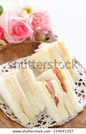 three type of delicious sandwich with flower on background
